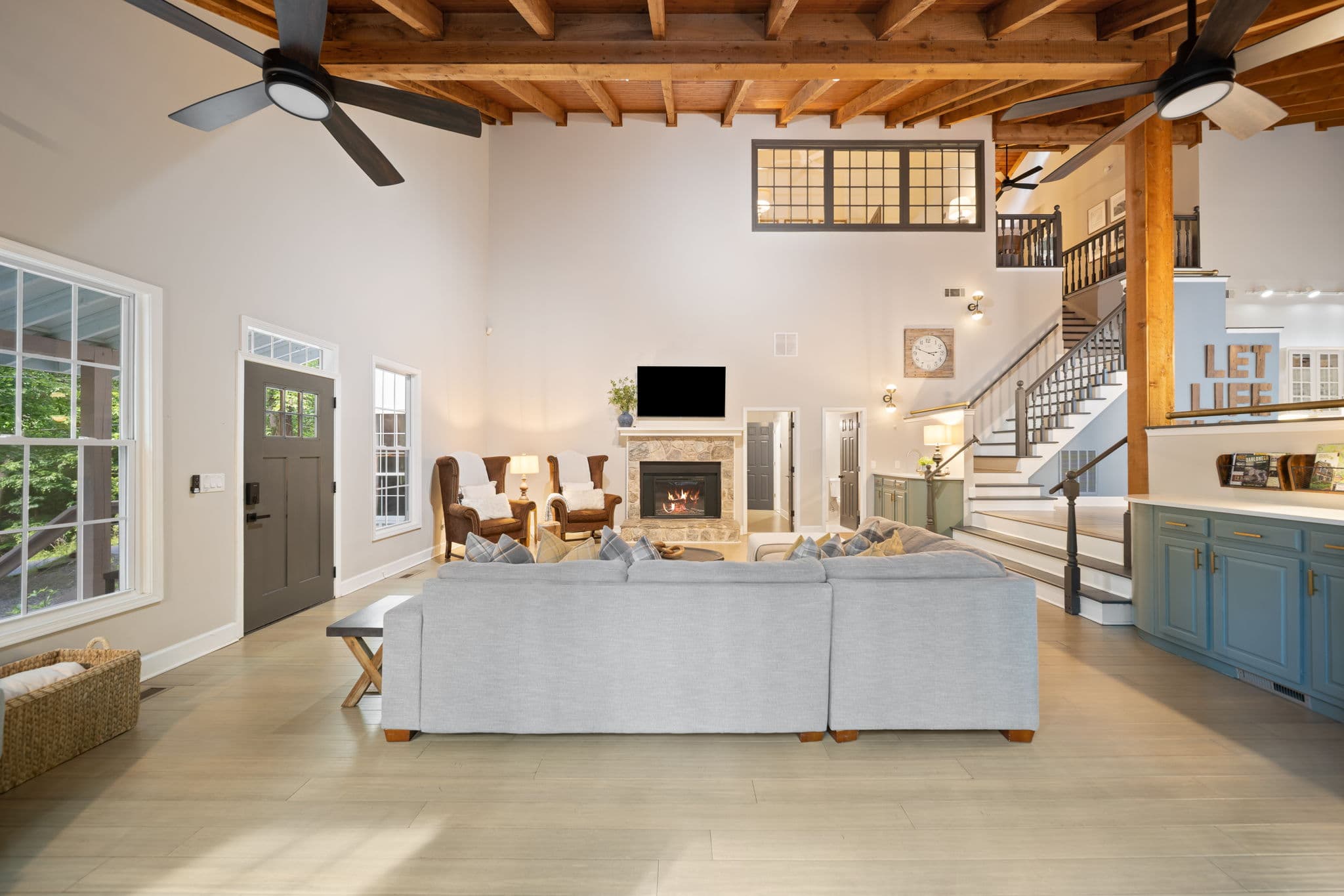 Cathedral ceiling great room with stone fireplace at Falling Water