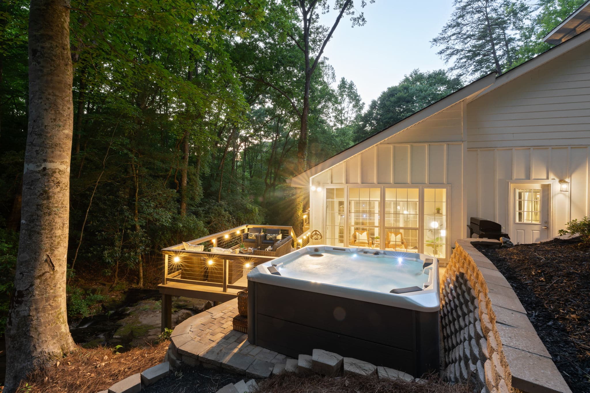 Creekside hot tub at twilight at Falling Water — romantic getaway in Dahlonega Georgia