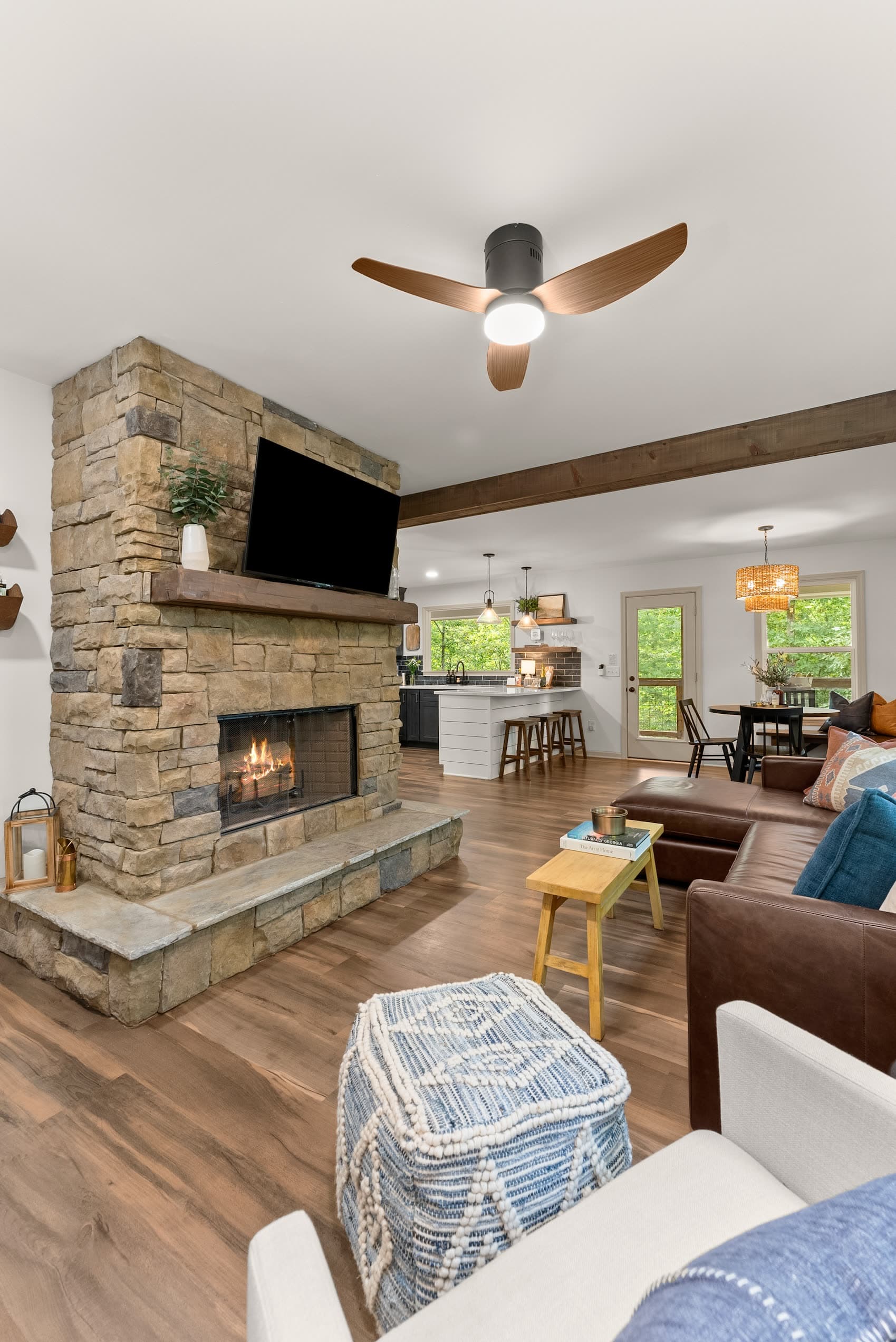 Stone wood-burning fireplace and open-plan living room at Reserve at Fireside